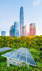 Ecological energy renewable solar panel plant with urban landscape landmarks in sunrise