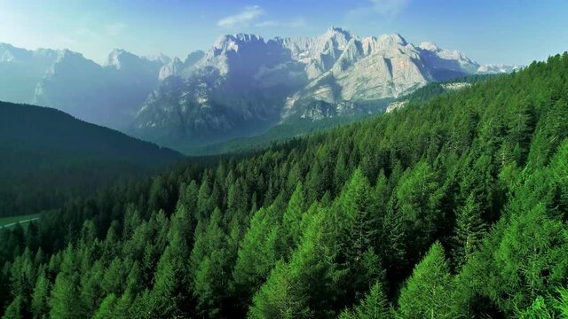 Aerial flight adove high mountain forest. Exploring Alps, Dolomites, Italy