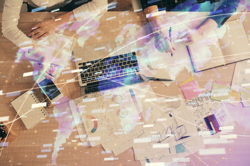 Double exposure of woman hands working on computer and data theme hologram drawing. Top View. Technology concept.