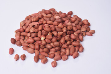 heap of raw peanuts on white background