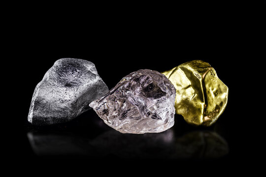 silver ore, gold nugget and rough diamond on black isolated background.