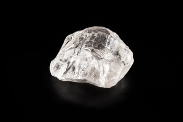 rough diamond on isolated black background, rare and precious mineral concept.