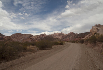 Dirt road into nowhere. Traveling along the arid desert route in the rocky mountains.	
