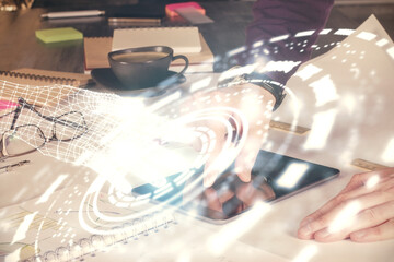 Double exposure of man's hand holding and using a digital device and data theme drawing. Technology concept.