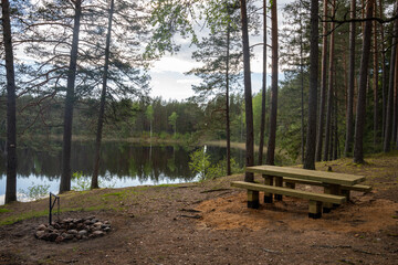 lake in the middle of the forest with very dark water and lots of pine trees along the lake shore