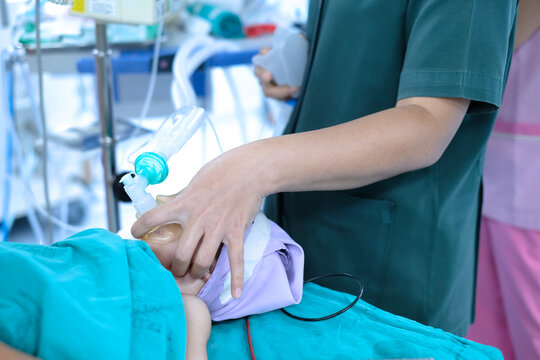 Nurse Holding Oxygen Mask For A Child Patient. General Anesthesia Before Cardiac Surgery