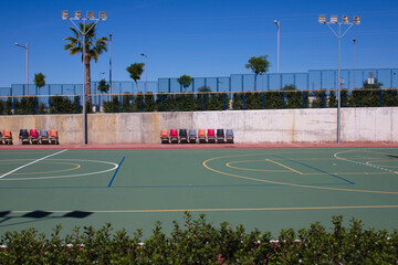 Detail of the university sports courts after classes when they are completely empty. You can see the chairs for the reserves of each sports team.
