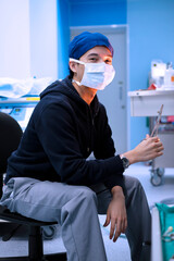 male perfusionist sitting in cardiac operating room