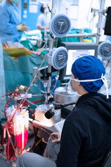 Fototapeta na wymiar male perfusionist sitting in cardiac operating room