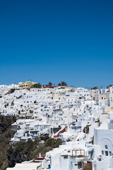 Fototapeta na wymiar Scenic cityscape of Imerovigli. city on the hill. White architecture. Santorini island, Greece. Luxury tourism.