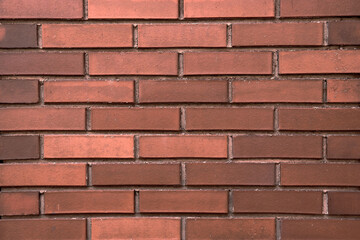 Red brick wall. Background with a brickwork texture. The walls of street houses. Loft style.