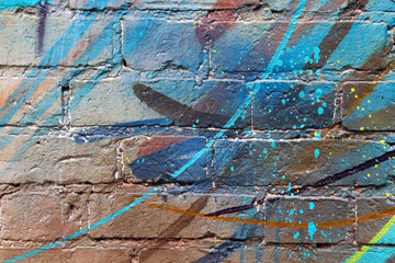 Abstract splashes, drops of paint on a brick wall. Street modern style. Street art. Painted walls. Vandalism. Randomness