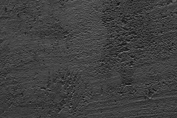 Black texture background. Concrete wall. Rough surface. Stone texture. Uneven, scratched, lumpy.