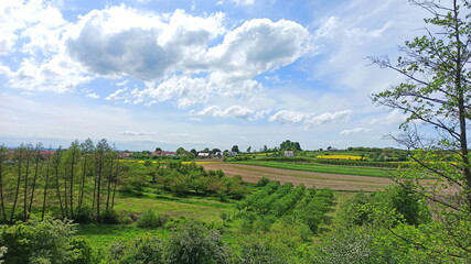 Fototapeta na wymiar Green landscape with blue sky and village in Lower Silesia area. Beautiful spring in Poland.