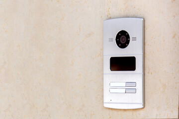 intercom with camera and speaker for control and security with a card reader for entering the building on the wall with copy space, nobody.