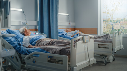 Hospital Ward: Elderly Old Lady and Young Beautiful Girl Resting in Beds, Fully Recovering from...