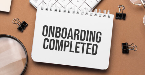 onboarding completed on notepad with pen, glasses and calculator