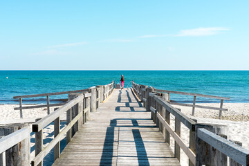 Bathing jetty on the Baltic Sea on a sunny summer day early in the morning. The sea and the sky are...