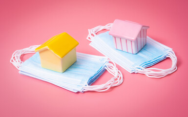 Model of a house with medical mask ,Coronavirus COVID-19 pandemic. Stay home concept