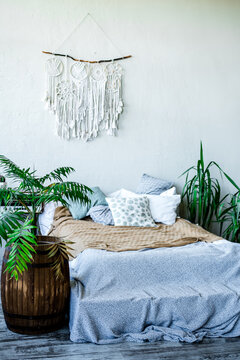 A Beautiful Dream Catcher Hanging Over The Bed In A Stylish Room Interior In White Shades