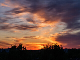 Fototapeta premium dark colorful sunset over city rooftops