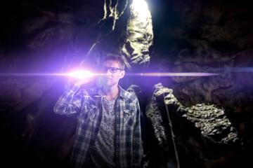 man with a torch light in the dark night, searching the way