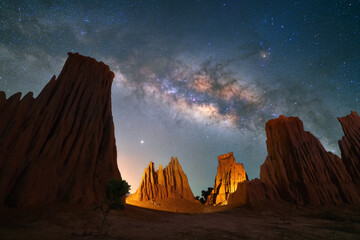 Beautiful milky way raised over natural earth pillar in various shapes crafted by soil erosion in...