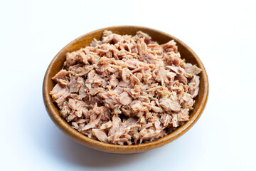 Canned tuna in wooden bowl on white background.