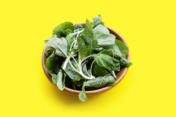 Amaranth white stem in wooden bowl on yellow background.