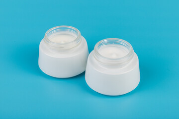 Beauty Cream Texture Close Up. Cosmetic skincare product in jar on blue background. High Quality