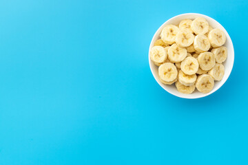 Banana slices in bowl. Fresh friuts top view