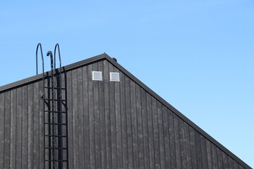 Top floor or a modern wooden house on a perfect sunny day. Scandinavian architecture.