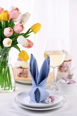 A napkin folded in the shape of a hare (rabbit), the concept of setting a festive table in honor of Easter.