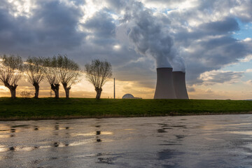Nuclear power plant by the river at sunset