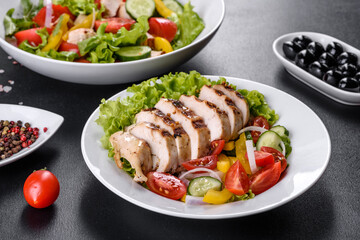 Fresh delicious salad with chicken, tomato, cucumber, onions and greens with olive oil