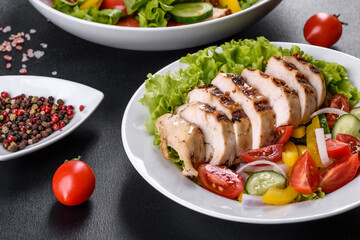 Fresh delicious salad with chicken, tomato, cucumber, onions and greens with olive oil