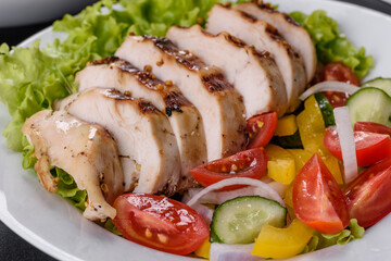 Fresh delicious salad with chicken, tomato, cucumber, onions and greens with olive oil