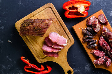 Grilled sausages with vegetables close up on an old table