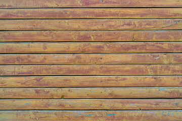 Old wood vintage planks covered with flaky brown paint.