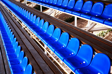 Fototapeta premium blue plastic seats in the sports arena. chairs on the football field. arena