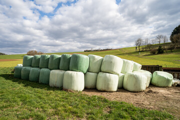 green agricultural farmland with hay bales