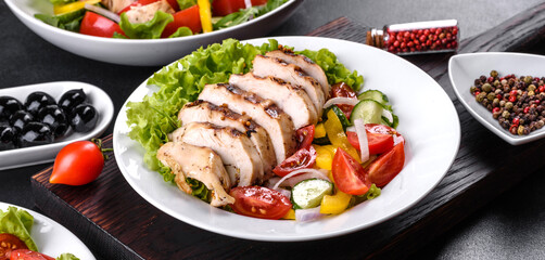 Fresh delicious salad with chicken, tomato, cucumber, onions and greens with olive oil