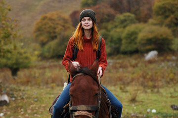 Fototapeta na wymiar cheerful woman tourist riding a horse nature fun adventure