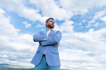 handsome man businessman in formal suit check time on wristwatch on sky background, agile business.
