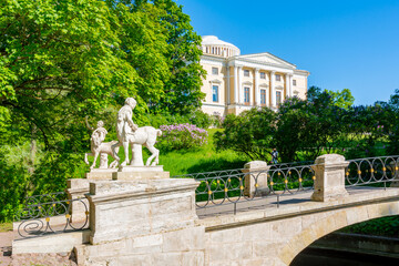 Naklejka premium Pavlovsk palace and Centaur bridge in Pavlovsky park, Pavlovsk, Saint Petersburg, Russia