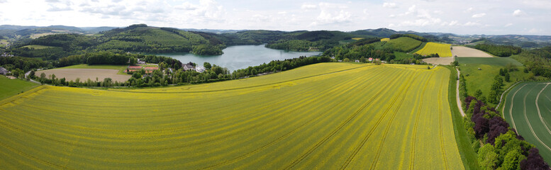 Middle hills Panorama with a big lake in the center - aerial view