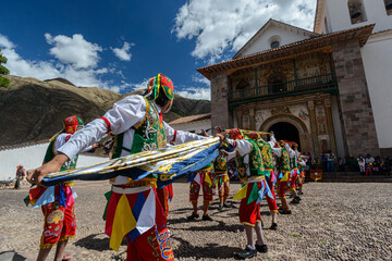 Peruvian folkloric dance, with colorful costumes in front of The Church of San Pedro Apostle of...