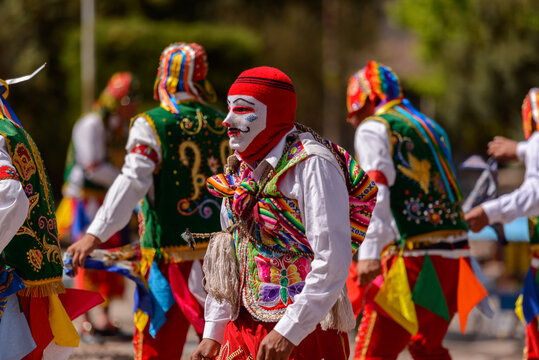 Peruvian folkloric dance, with colorful costumes in front of The Church of San Pedro Apostle of Andahuaylillas, Quispicanchi, near Cusco, Peru on October 7, 2014.
