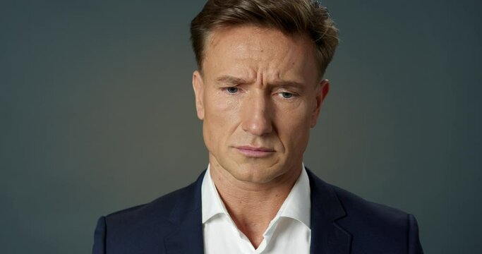 Sad Businessman Looking at Camera Sighing Hard. Handsome Adult Male Manager Unhappy Portrait. Close-up Face Rueful Man. Disappointed Look of Employee. Modern Business Technology Concept.