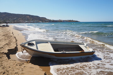 Łódź na piaszczystej plaże przy falach, Kreta, Grecja - obrazy, fototapety, plakaty